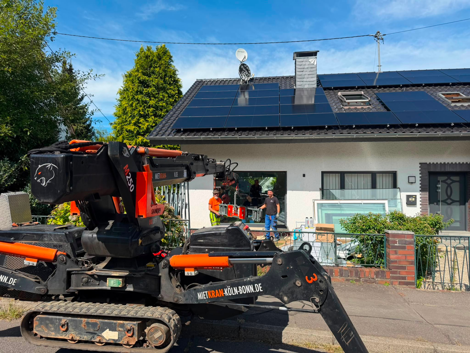 Montageteam mit Vakuum-Glassauger bei der Kranmontage in Köln